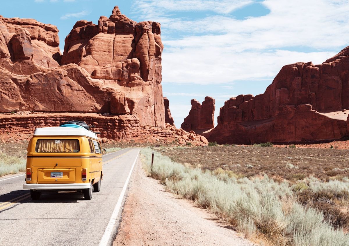 A car on a highway crossing a state line — legal traps for road trips in 2026